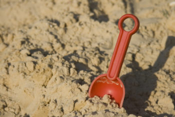 Toy shovel in sand